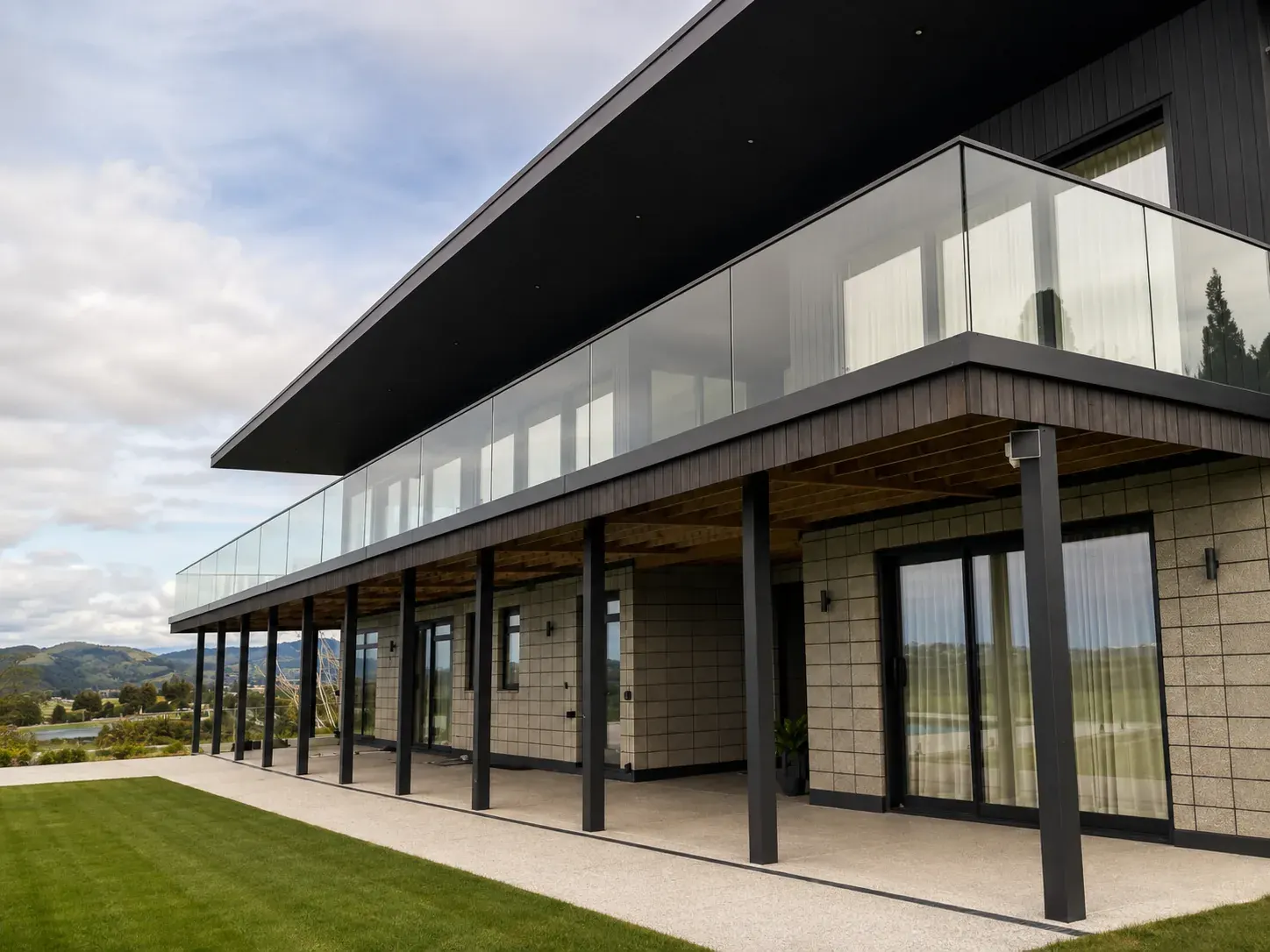 First Glass Solutions frameless glass balustrade along an upper deck of a modern home